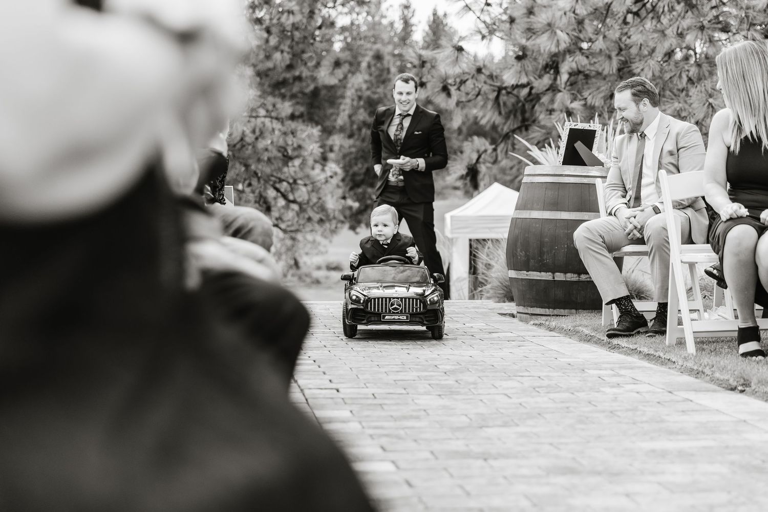 A black and white wedding photo collage showing multiple candid moments and romantic scenes outdoors.