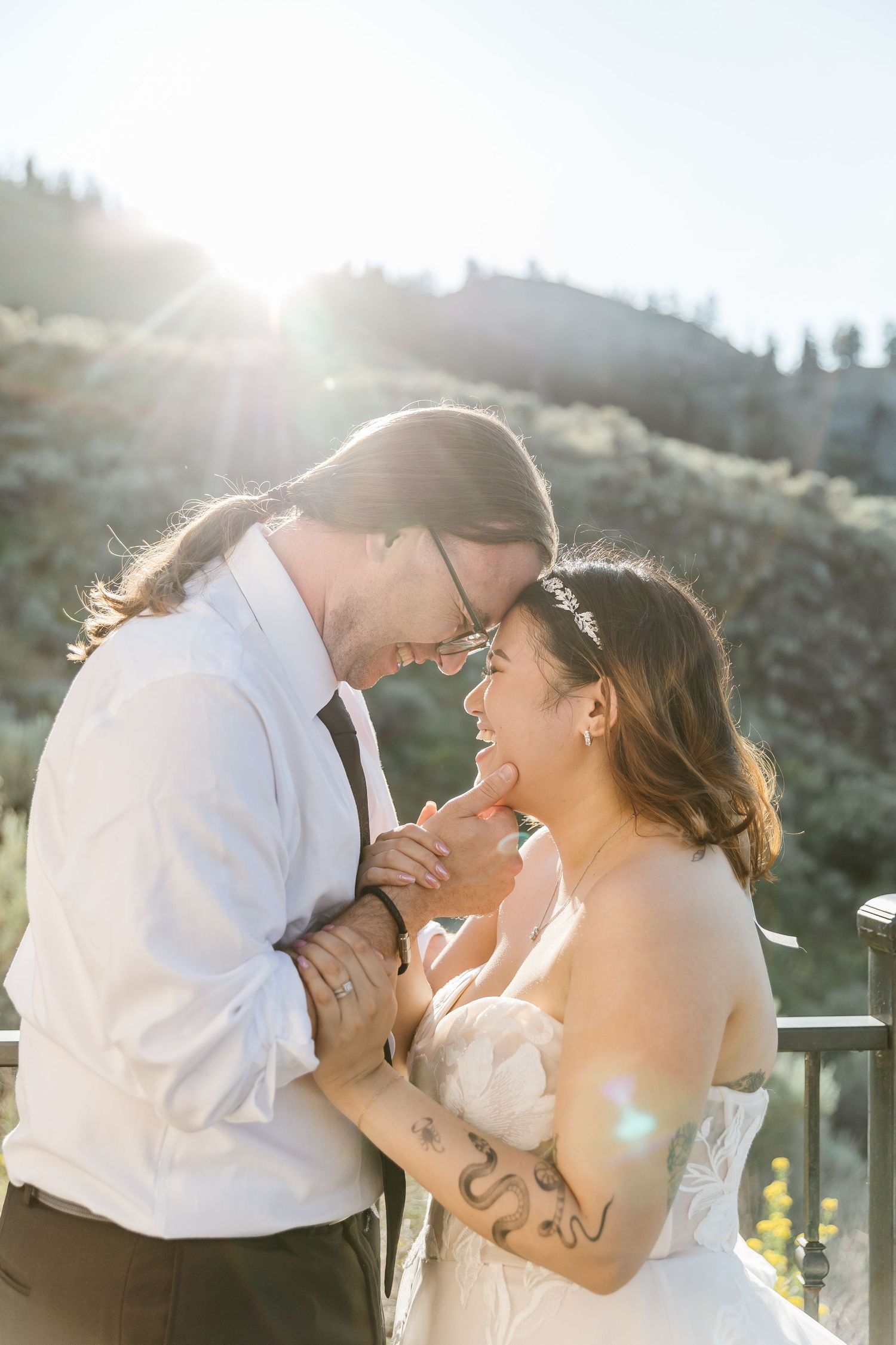 Romantic sunset wedding photos with golden light streaming through the mountains.