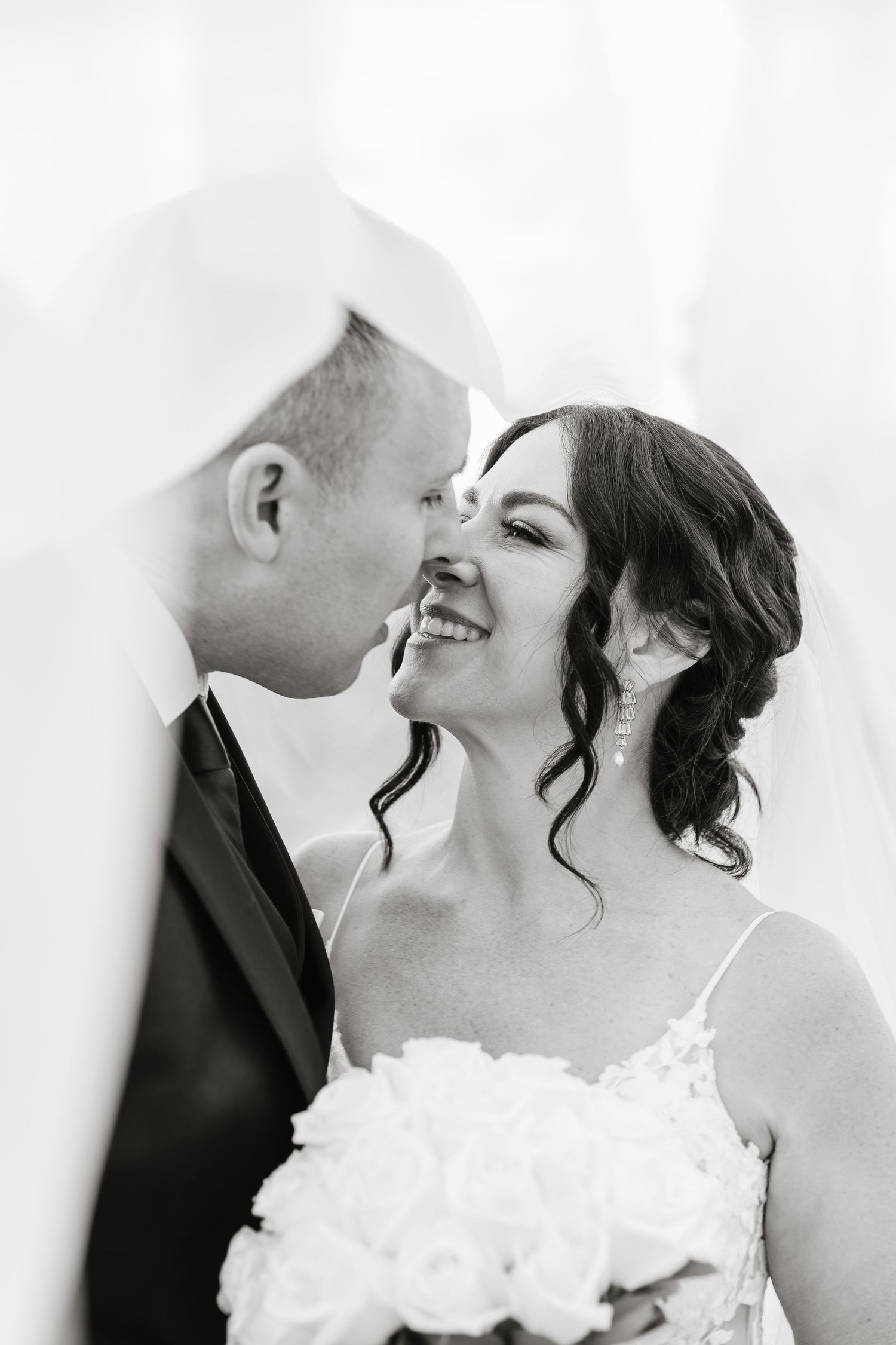 A series of intimate wedding kiss photos captured in black and white against a light background.