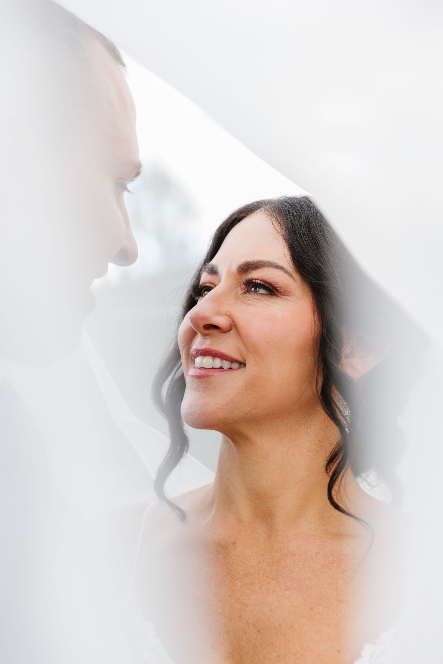 A series of four profile shots showing a woman's joyful expressions against a white background.
