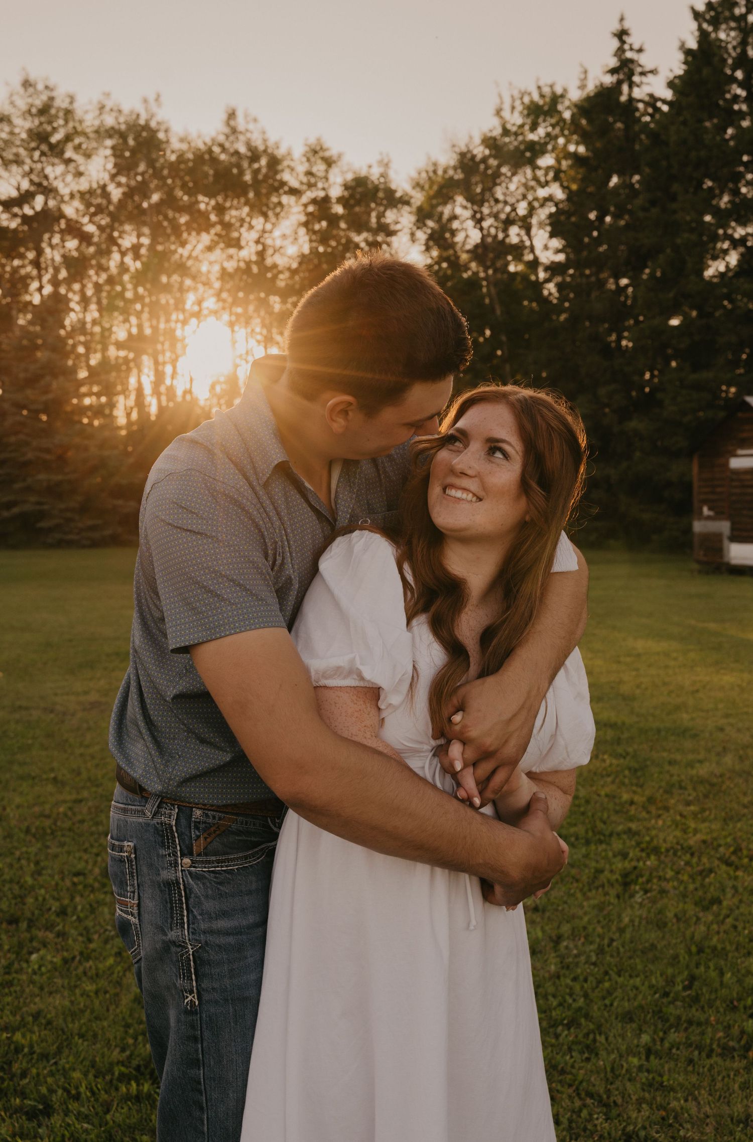 Playful couple sharing a piggyback ride moment in a cozy cabin living room.