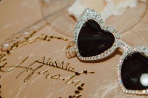 Wedding accessories and jewelry arranged on vintage handwritten paper.