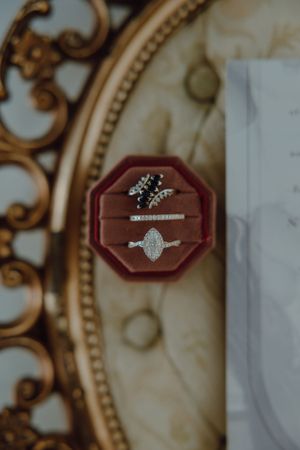 A stunning diamond engagement ring displayed in an elegant burgundy velvet ring box.