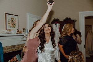A candid moment of celebration and dancing at a wedding reception.