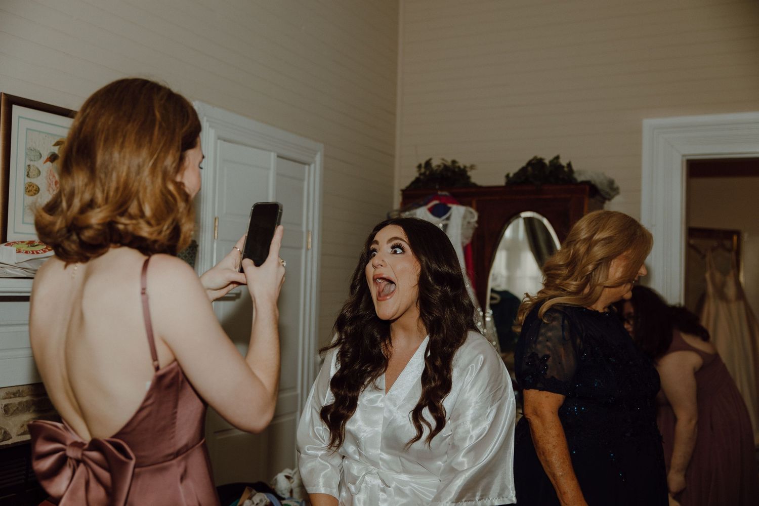 Wedding party members celebrating and dancing together indoors.