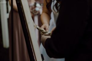 A tender moment captured during a wedding ceremony in dramatic lighting.