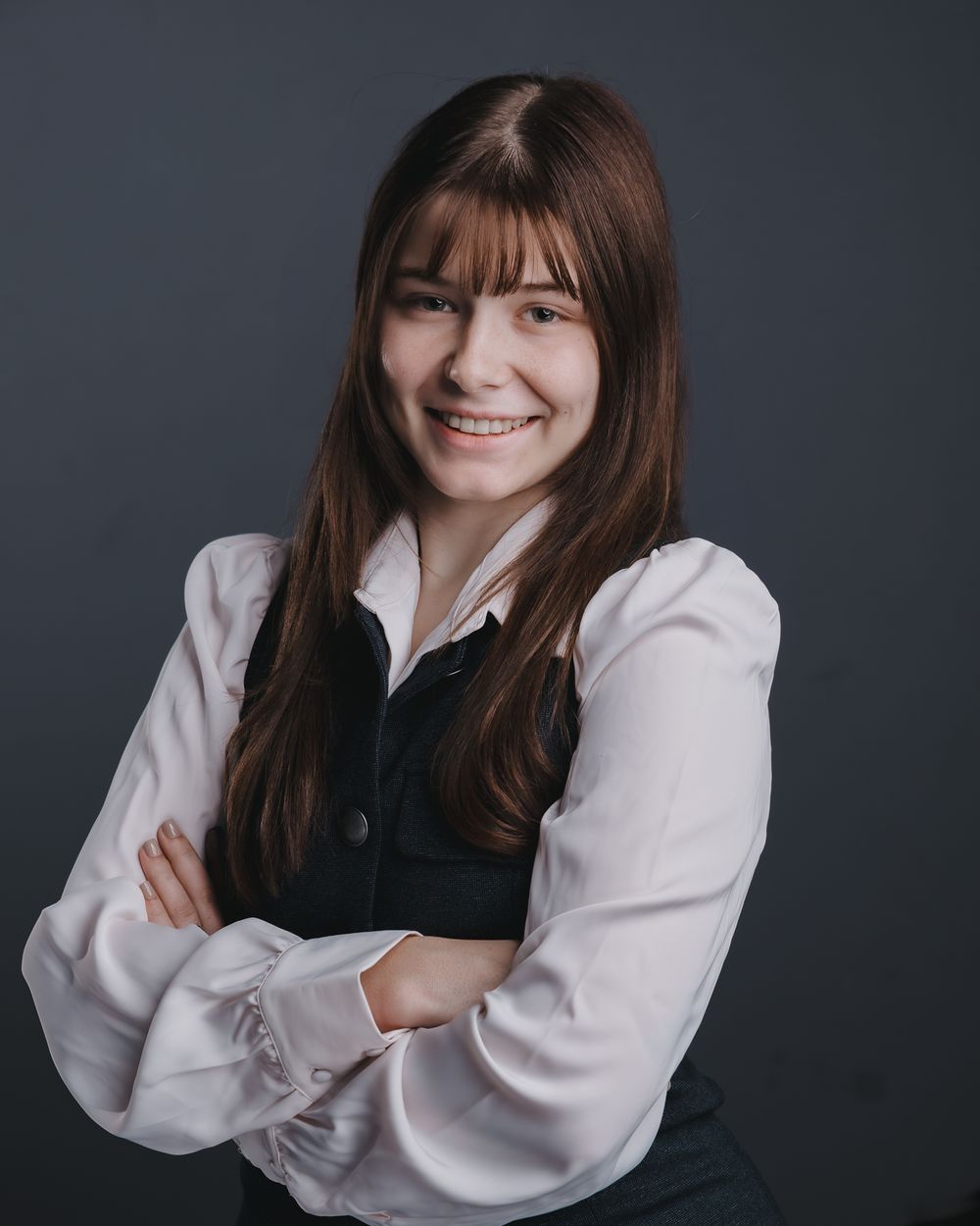 Professional studio portrait series showing joyful expressions against dark background in white and black attire.
