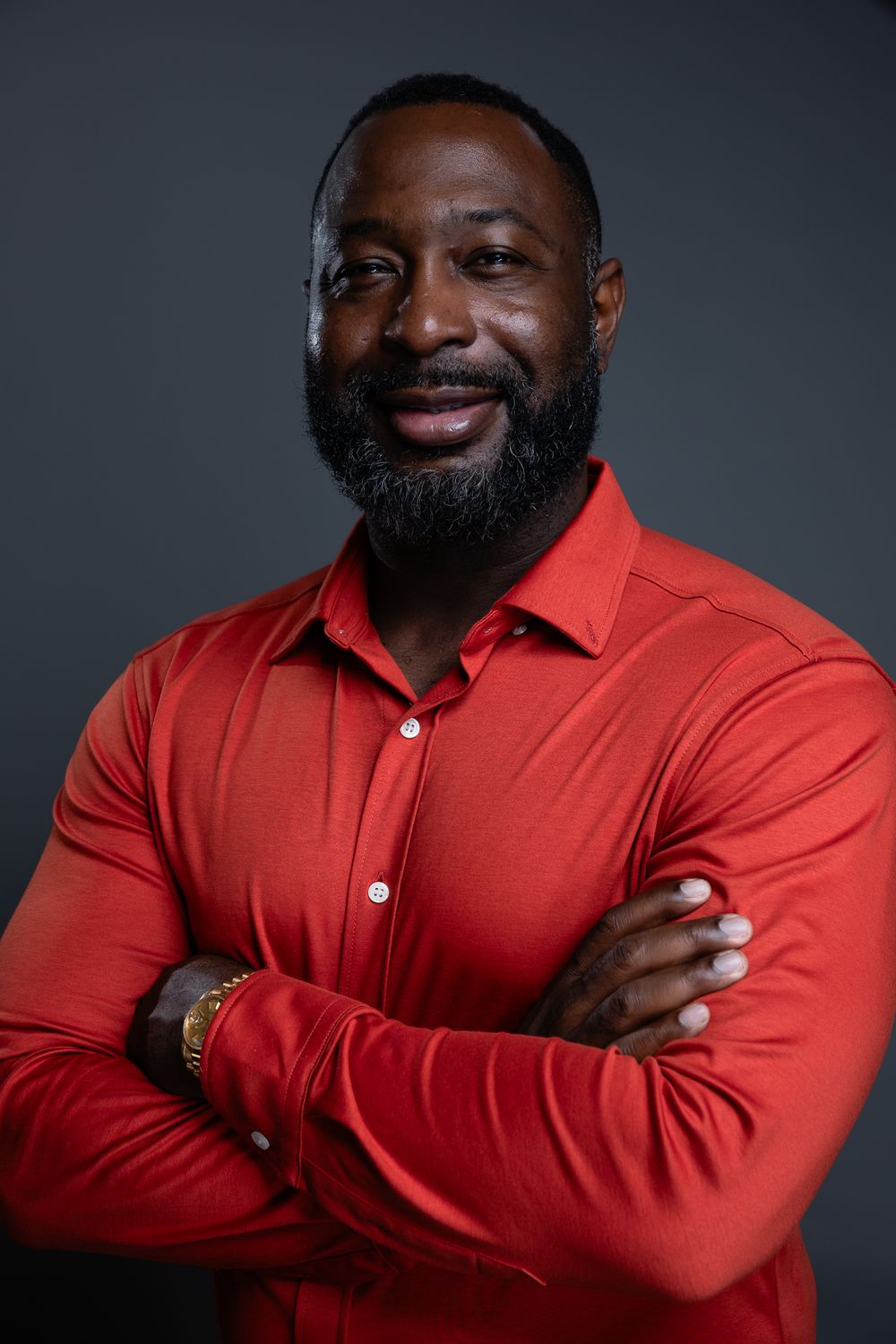 A sequence of studio portraits showing someone in a bright red button-down shirt against a dark gray background.