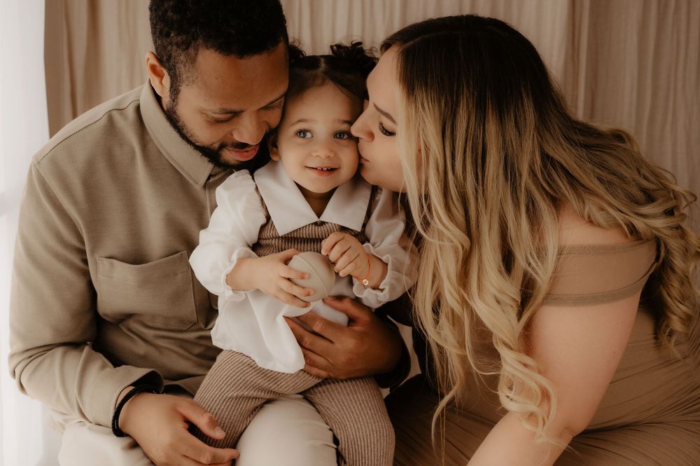 Intimate family moment captured in warm natural tones with soft lighting.