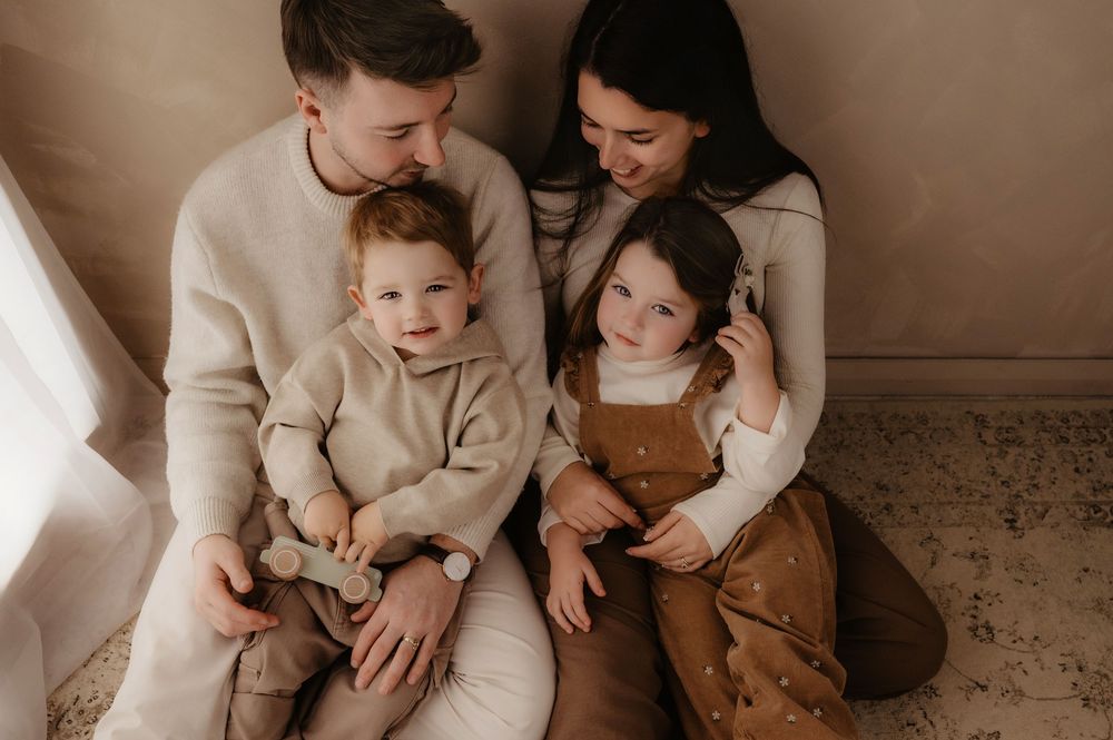 A collection of warm-toned family photos showing tender moments between parents and children in matching neutral outfits.