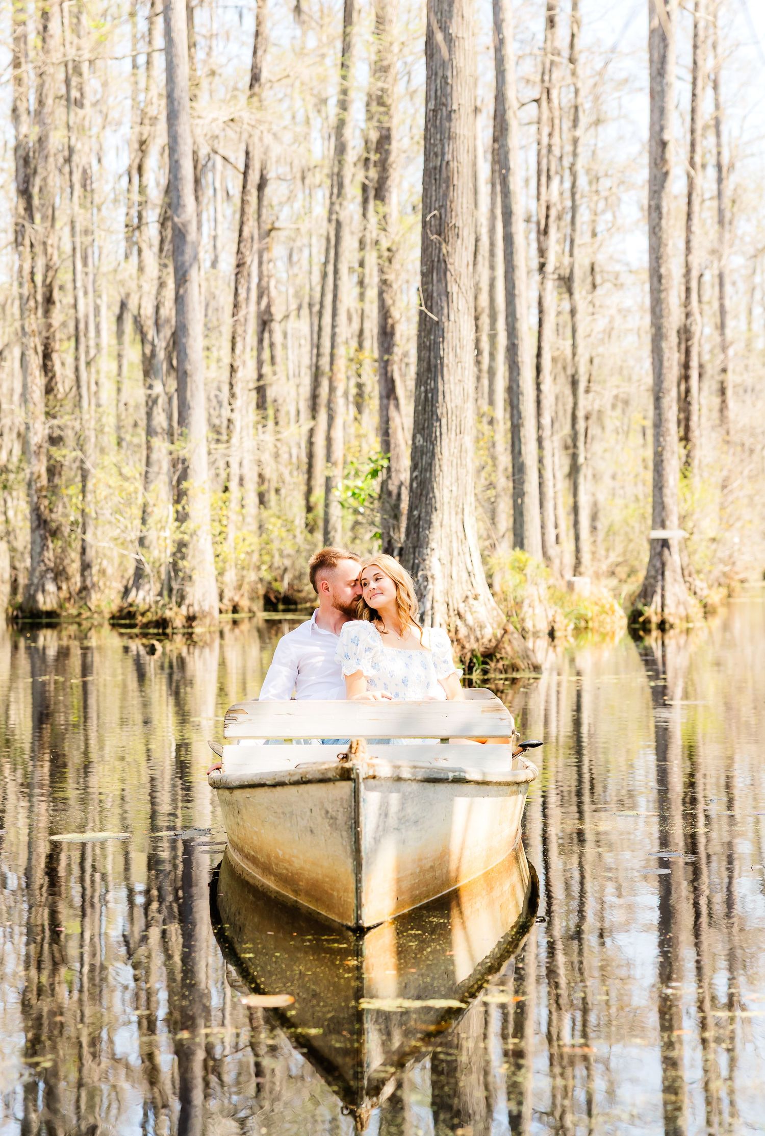 Two boats float peacefully in a misty swamp with reflective water. PRESLEY ROSE PHOTOGRAPHY CYPRESS GARDENS CHARLESTON SC MOUNT PLEASANT