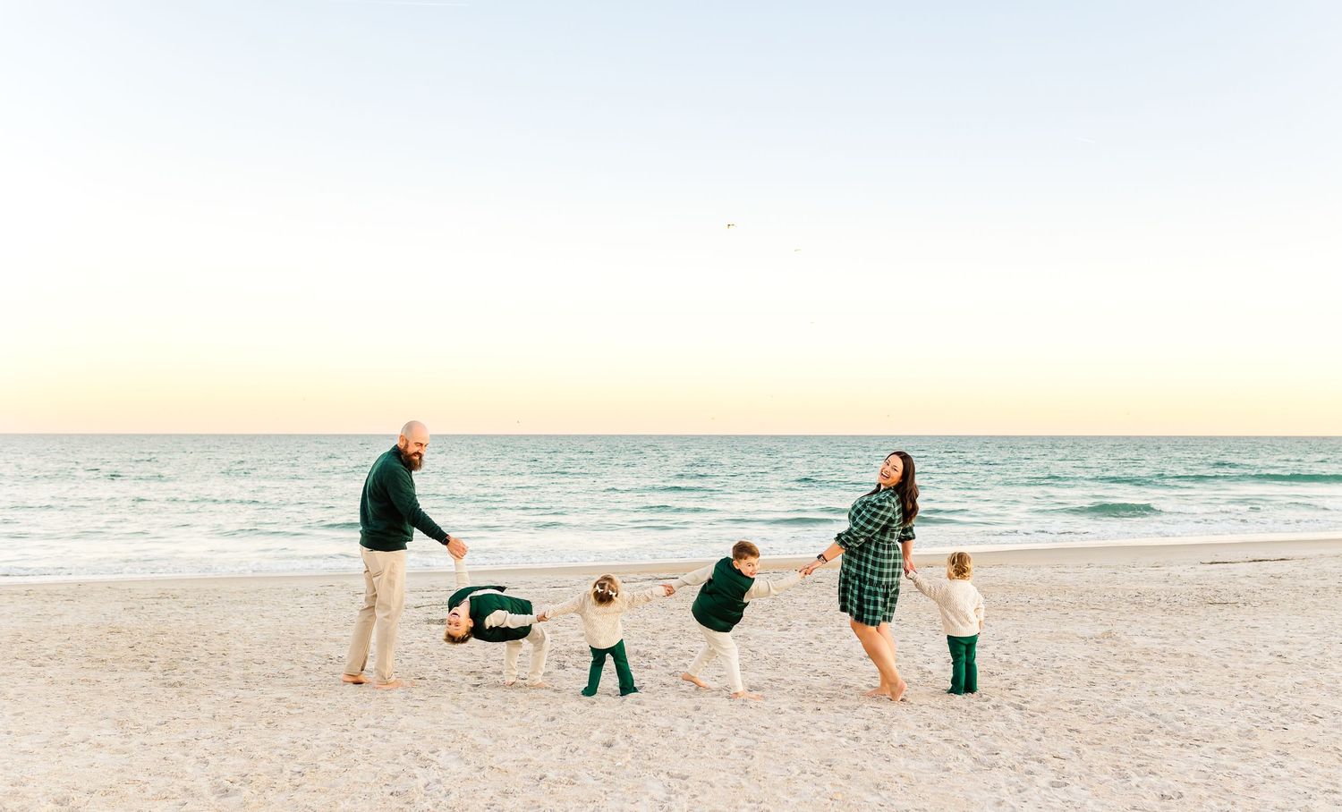 Group playing and running together on a sunny beach at sunset.PRESLEY ROSE PHOTOGRAPHY OCEAN ISLE BEACH SUNSET BEACH BRUNSWICK BEACH WILMY