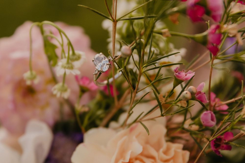 Delicate arrangement of pink roses and small white flowers in soft focus.