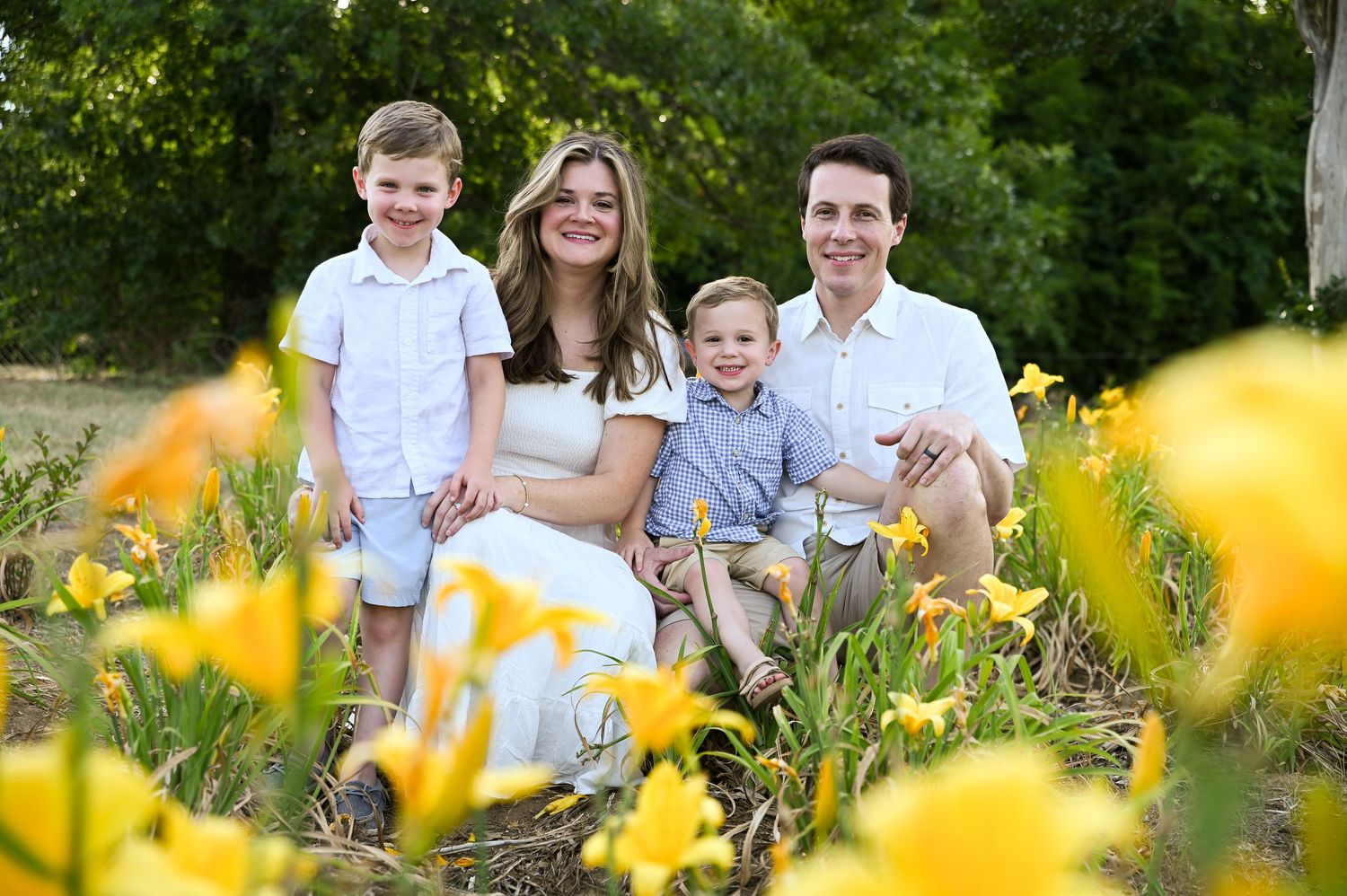 family in field of yellow flowers