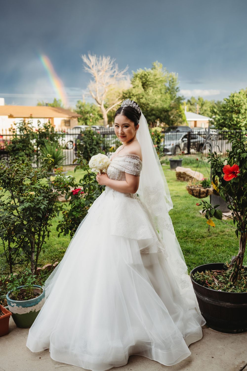 Bridal portrait in front of a rainbow and stormy skies in Albuquerque, New Mexico.