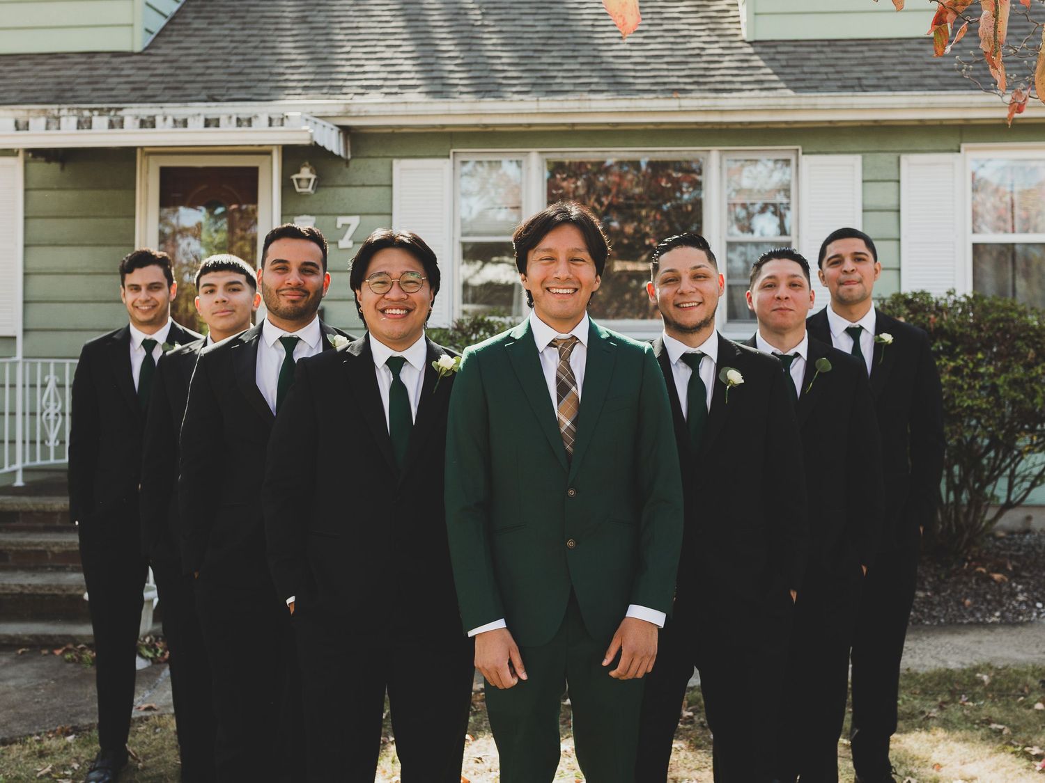 "Groom with groomsmen in formal suits posing outside before wedding ceremony – candid wedding party photo by luxury photographer"