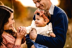 Family sharing intimate moment together during golden hour photoshoot.
