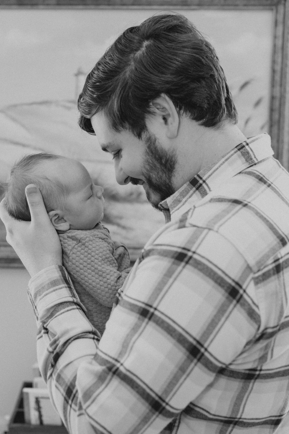 Father with newborn son during newborn lifestyles session in Irmo, SC.