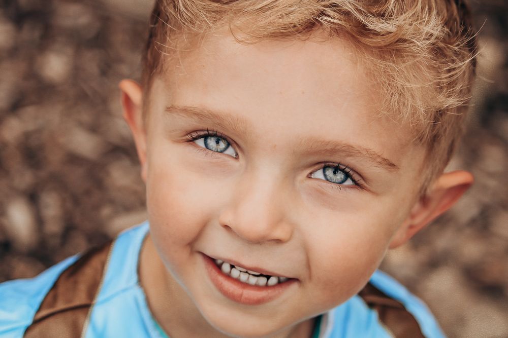 Close-up portrait showing bright eyes and joyful expression.