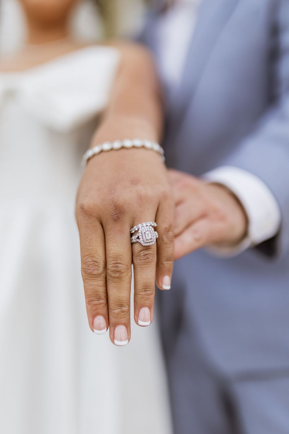 Close-up of a sparkling diamond engagement ring and bracelet on display.