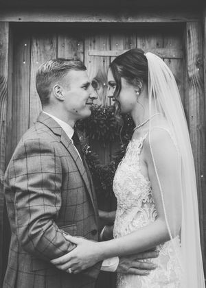 Black and white wedding photos show intimate moments between a bride and groom in formal attire.