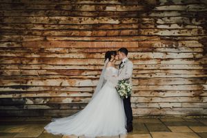 Bride and groom share intimate moments against rustic brick wall backdrop in wedding photography sequence.