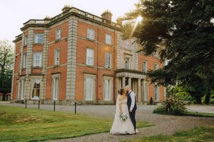 A grand historic mansion with brick exterior and classical architecture is shown in multiple wedding photography angles.