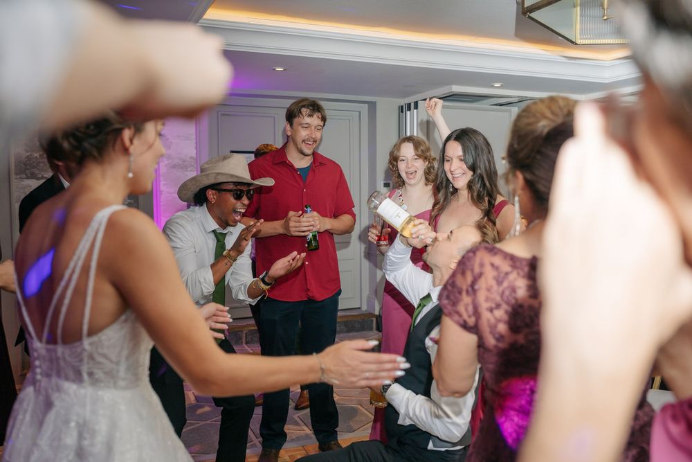 Guests dancing and celebrating at a lively wedding reception party indoors. warwickshire wedding photographer