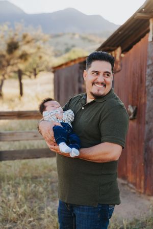 Sweet moment captured with baby during outdoor family photoshoot in desert setting.
