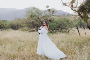 Family portrait session in desert setting with mountains and natural vegetation.