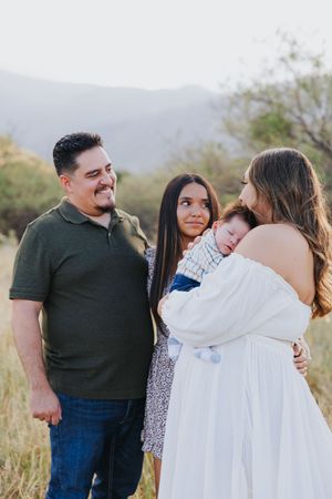 Candid family moments captured during outdoor desert photoshoot.