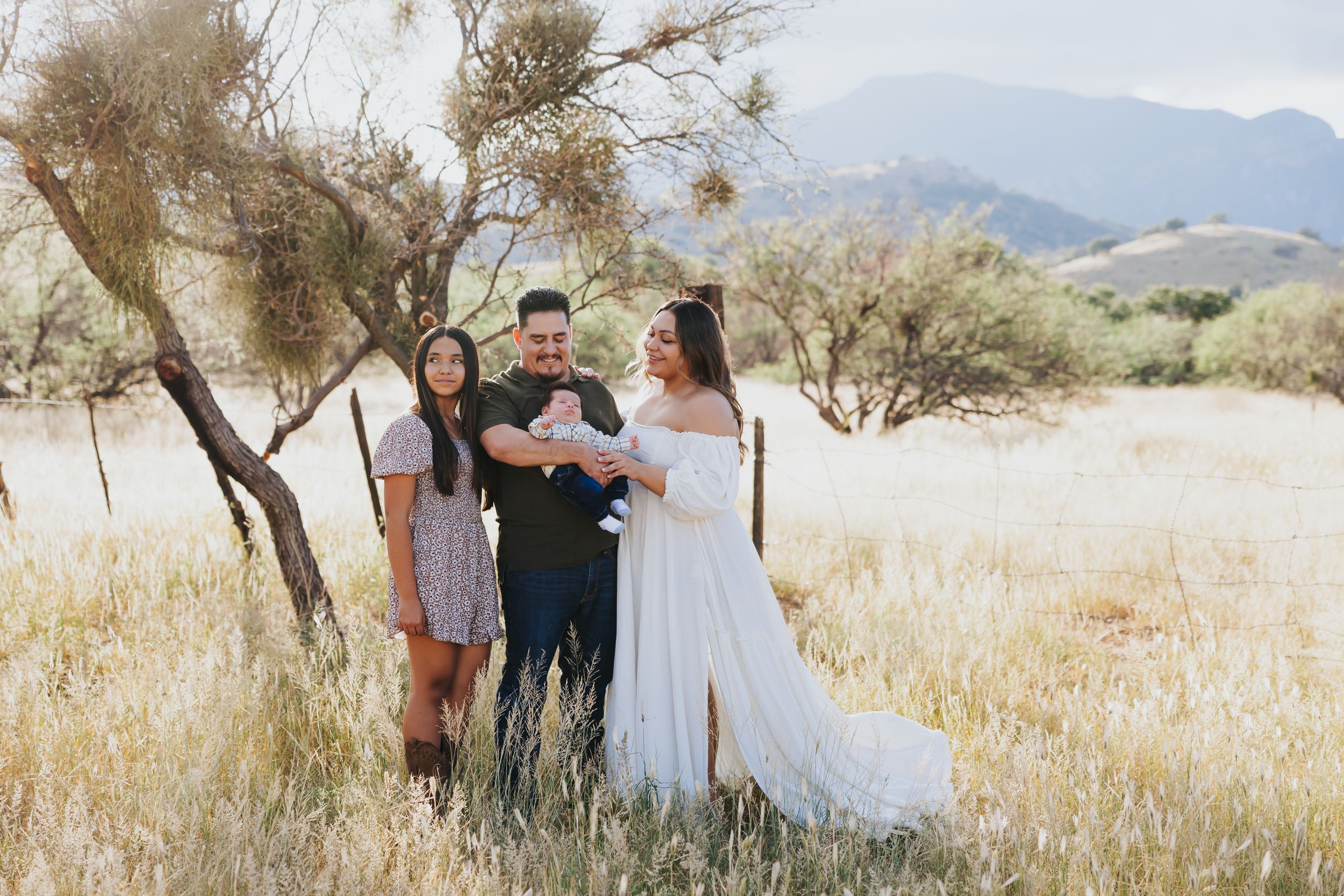Desert landscape family portrait session with mountains in the background.