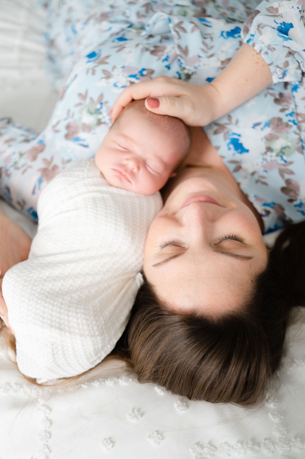 Close-up shots of a baby resting on floral patterned bedding.