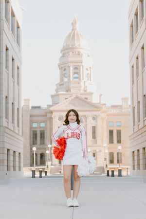 Artistic photo series with white buildings and red pom poms in an architectural setting.