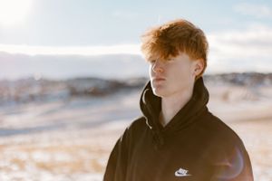 Moody beach portraits captured during golden hour against coastal landscape.