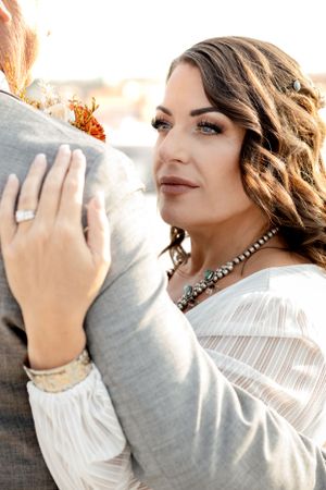 Professional portrait series showcasing artistic makeup and jewelry against a warm sunset backdrop.