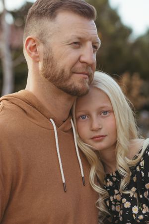Cozy autumn portrait session featuring brown hoodie and floral print clothing.