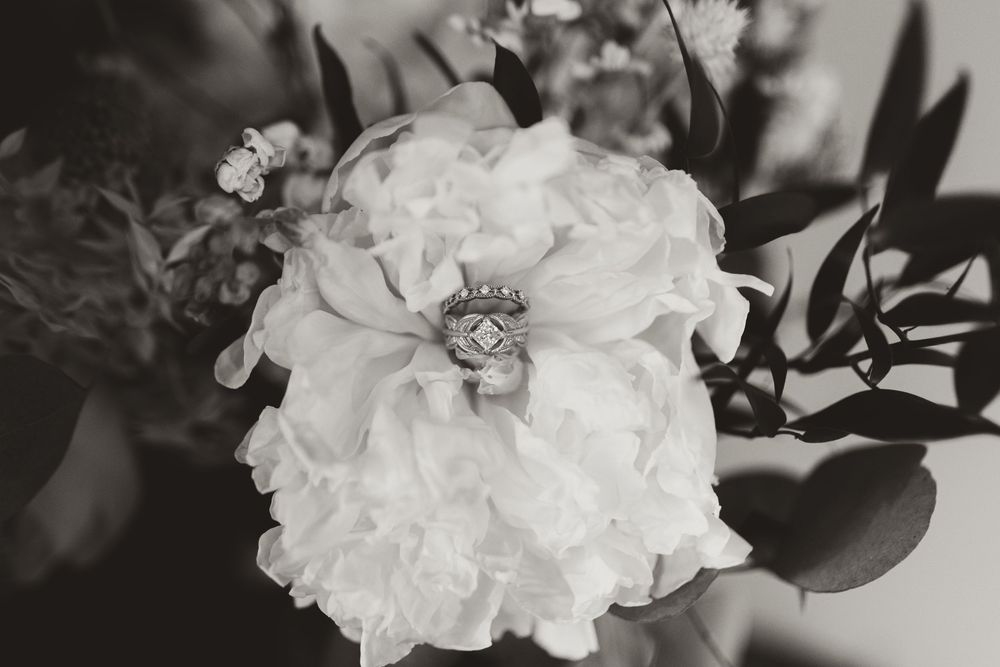 Close-up details of elegant white floral arrangements with soft petals in black and white.