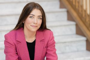 Professional headshots featuring a pink blazer against a light background.