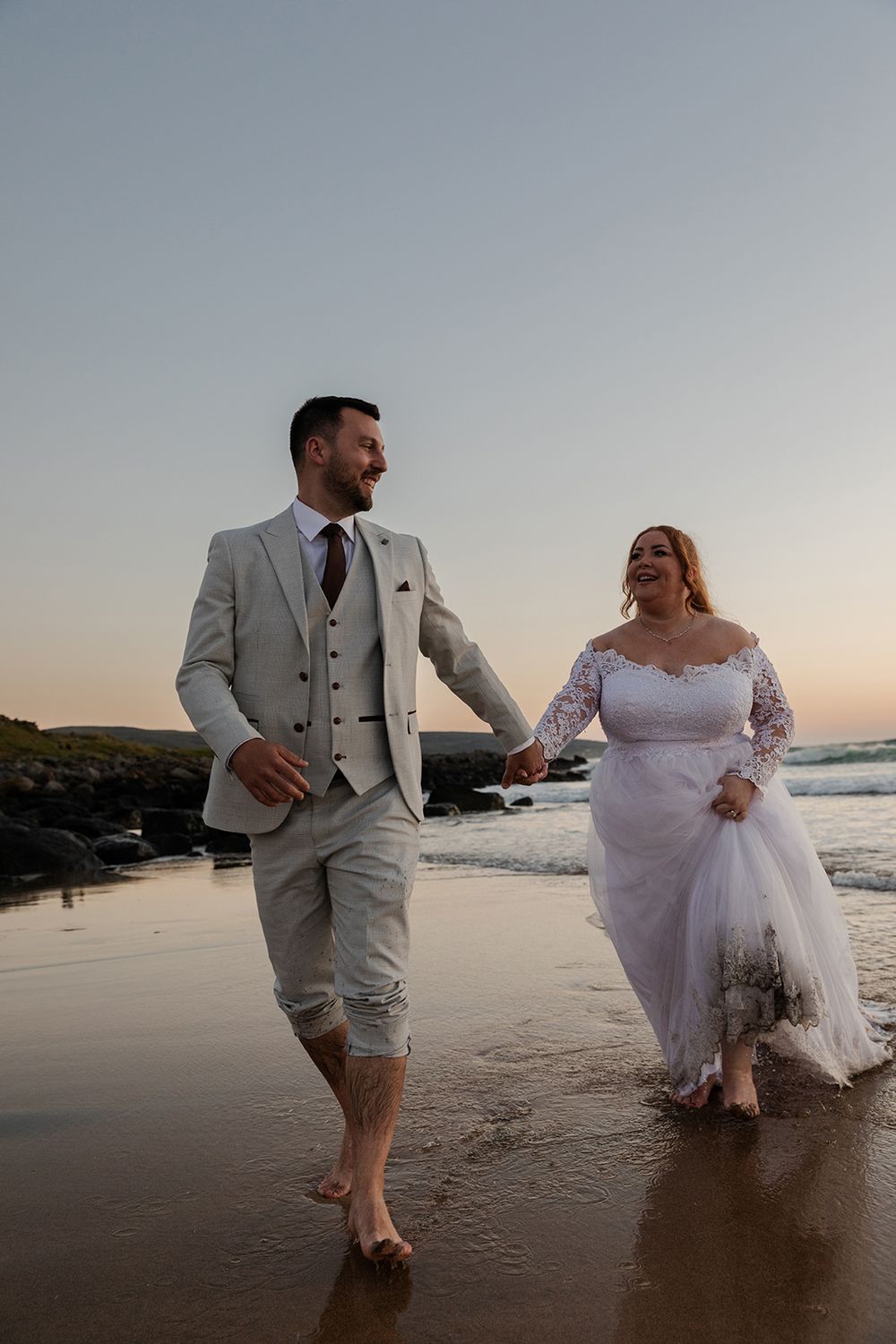 newlyweds having fun photo session at the Fanore beach after the ceremony