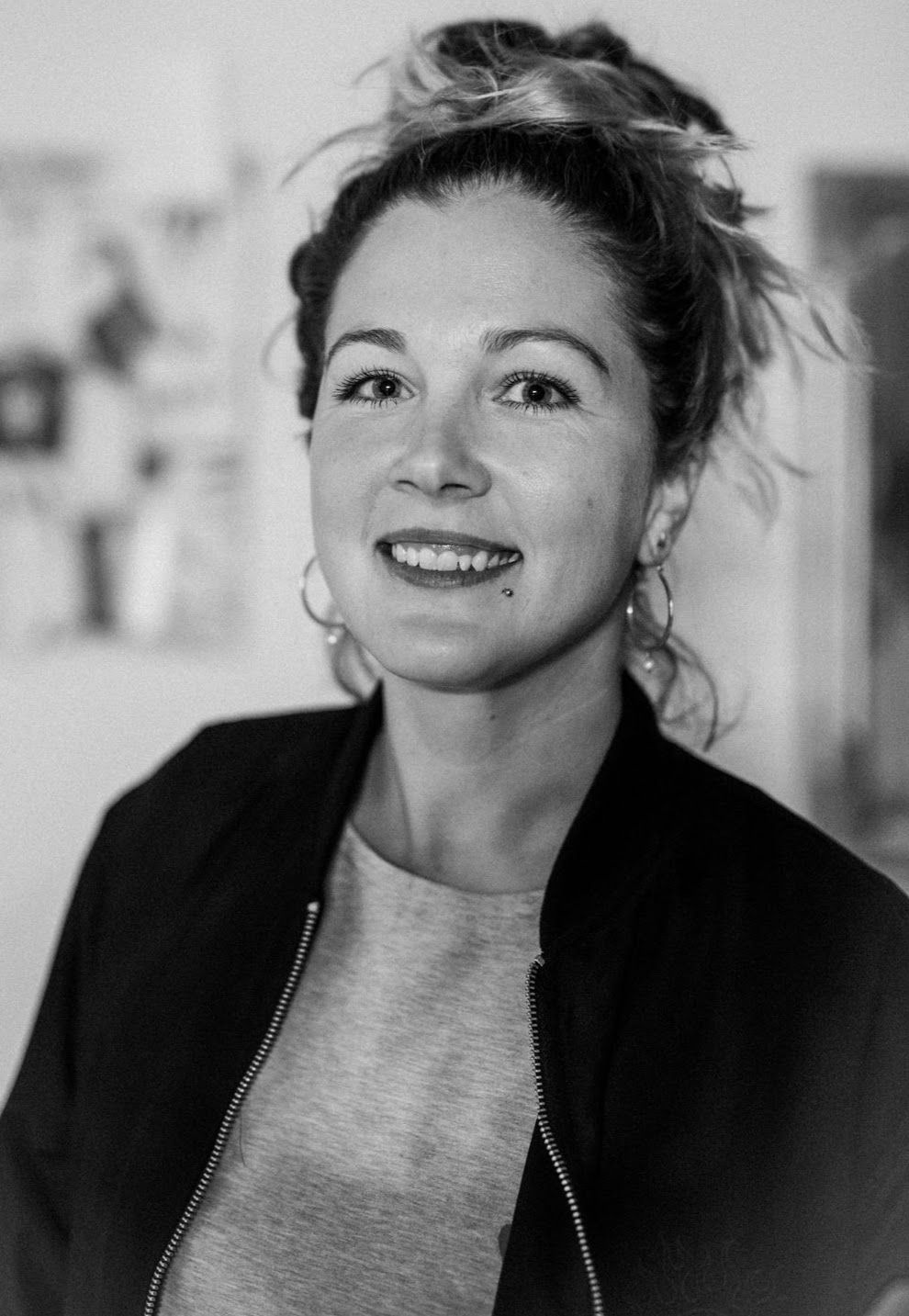 A series of expressive black and white portrait shots showing joyful emotions.