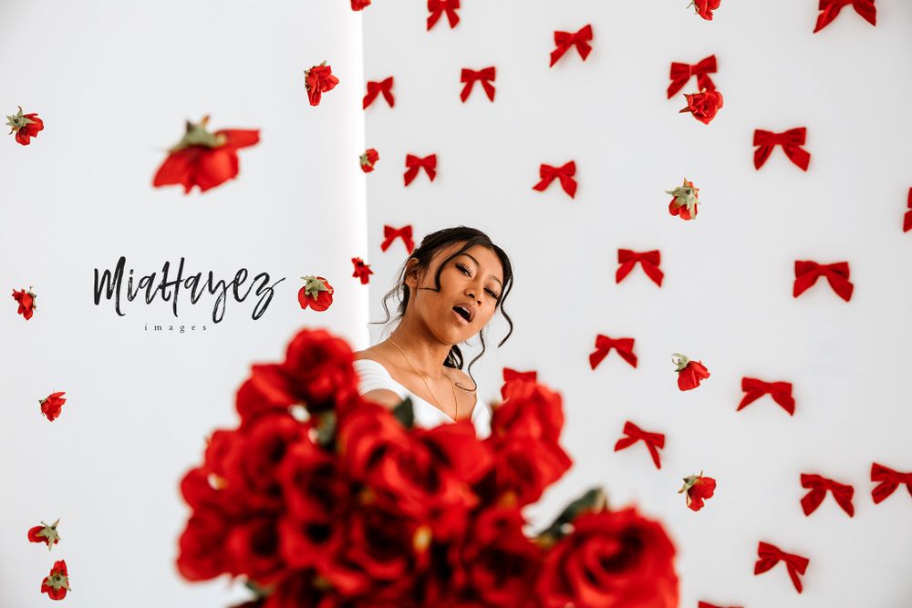 Decorative scene with red bows and romantic elements against white background.