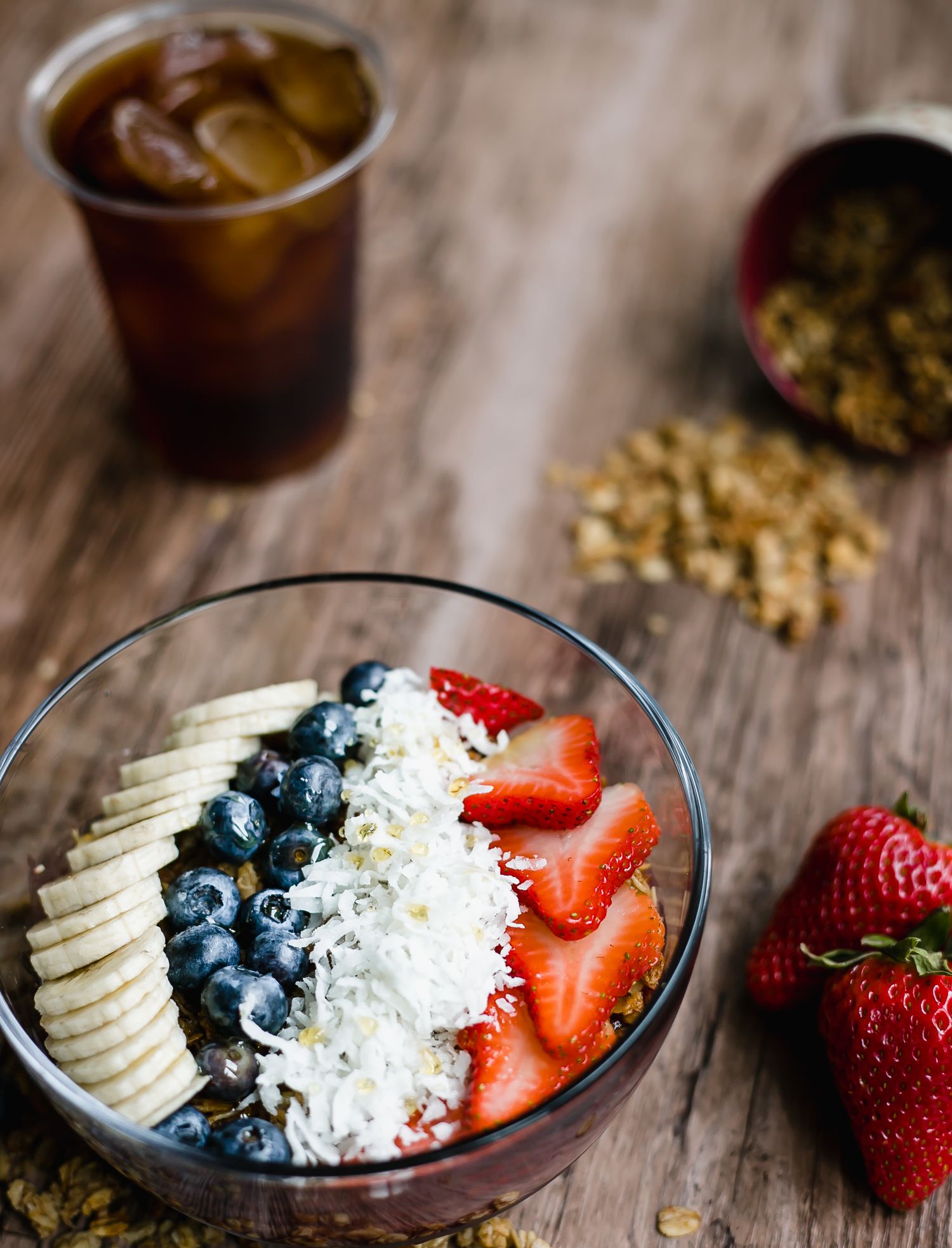 Healthy acai bowl topped with fresh berries, banana slices, and coconut flakes.