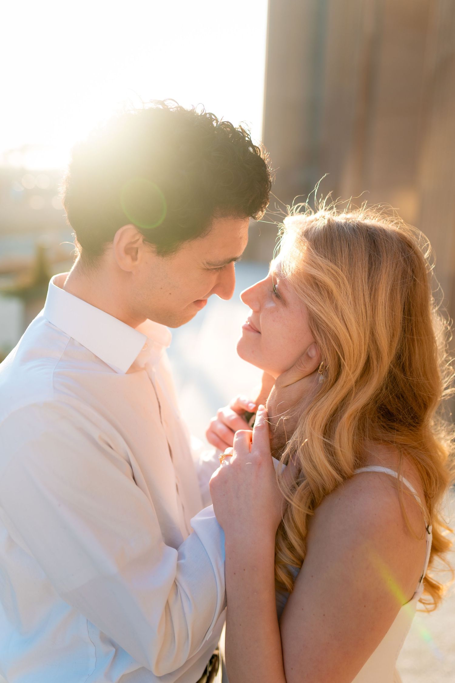 Romantic couple shares intimate moments at sunset in a series of soft backlit portraits.