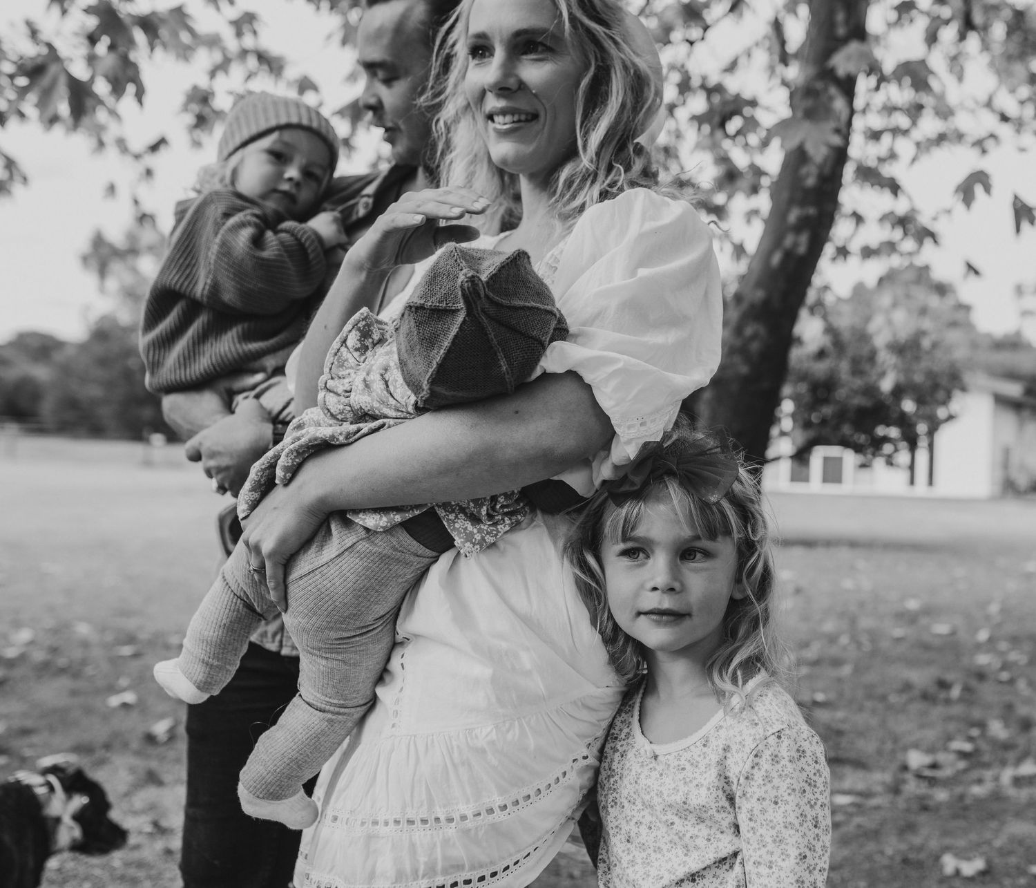 Family enjoying autumn day together outdoors in black and white.