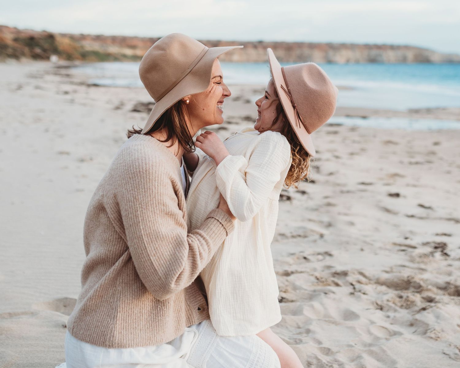 Intimate moments shared on a sandy beach during golden hour.