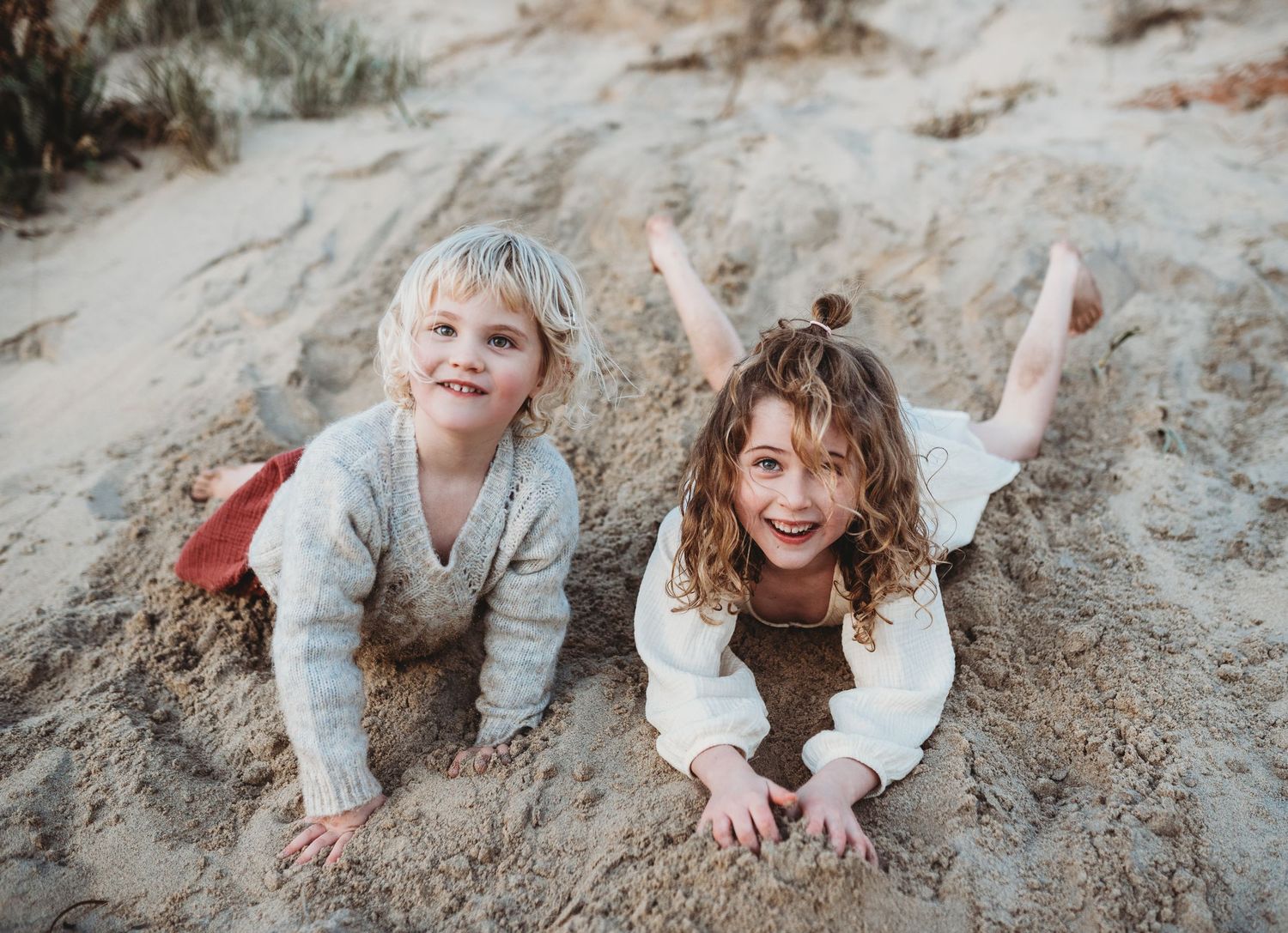 Candid moments of fun and laughter on coastal sand dunes.