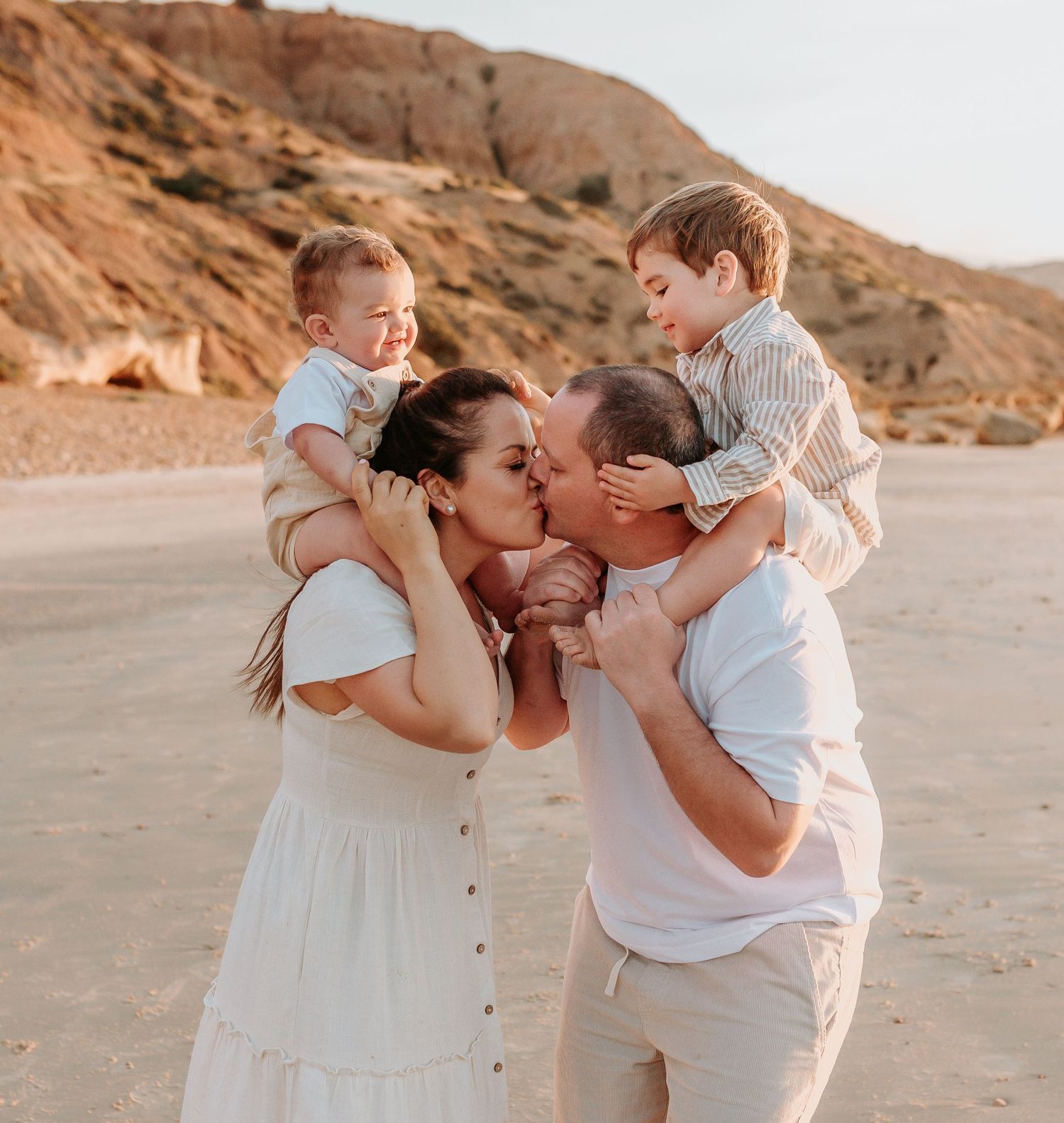 Sweet family moments captured during a sunset beach photoshoot.