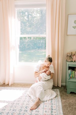 A series of boudoir photos showing someone in white fabric posing artistically on a patterned rug in a sunlit room.
