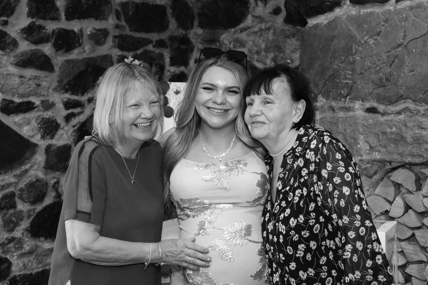 Candid celebration moments captured against rustic stone wall interior.